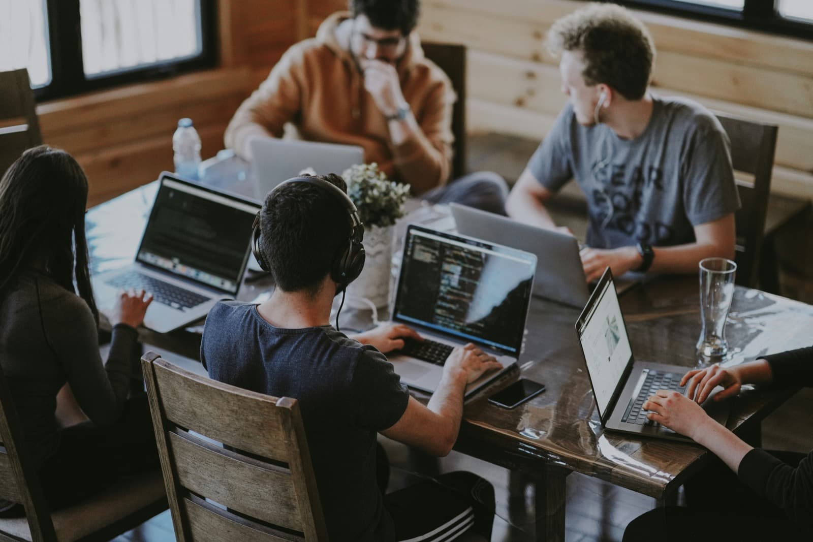A web design team collaborating around a laptop in an office